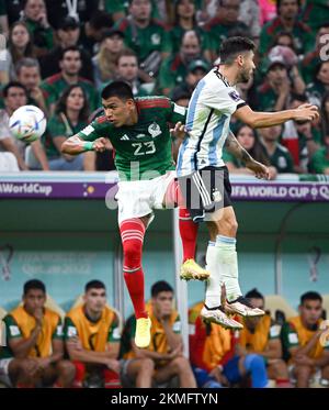 Lusail, Qatar. 26th Nov, 2022. Jesus Gallardo (L) of Mexico heads the ball during the Group C match between Argentina and Mexico at the 2022 FIFA World Cup at Lusail Stadium in Lusail, Qatar, Nov. 26, 2022. Credit: Li Ga/Xinhua/Alamy Live News Stock Photo