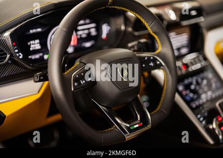 Ternopil, Ukraine- November 11, 2022:  Steering wheel of yellow Lamborghini Urus. Stock Photo