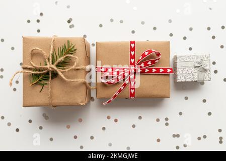 Three gifts in beige wrapping paper tied with brown ribbons on brown Stock  Photo - Alamy
