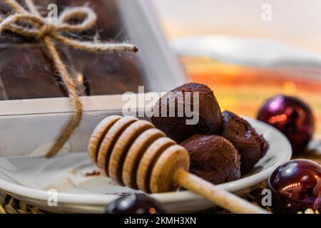 Honey truffles over wood, box and plate with Christmas decorations Stock Photo