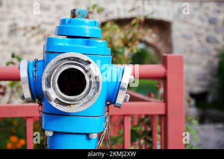 Blue public fire hydrant on the street. Fire supplies and equipment for city security Stock Photo