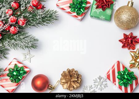 Christmas composition. Gifts, fir tree branches, gifts, presents, and red decorations on white background. Christmas, new year concept. Flat lay, top Stock Photo