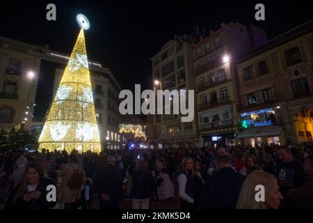 People are seen gathered during the switching on of the Christmas lighting at Plaza de la Constitucion square. Amid energy crisis and the increase of price electricity, Malaga city turns on its Christmas lights to mark the Christmas season, where thousands of people gather in downtown city to see a new Christmas decoration and lights show. Stock Photo