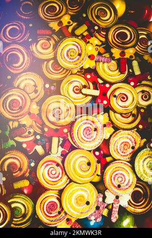 Retro revival art on a rainbow of old-fashioned sweet treat toys displayed with flares of 1960. Wooden lollipops