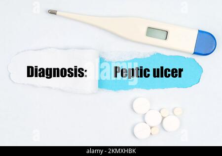 Medical diagnosis. A gap is made in the middle of the white sheet, inside of which there is an inscription - Peptic ulcer on a blue background. On the Stock Photo