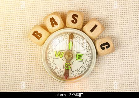 Business concept. On the table is a compass and cubes with the inscription - BASIC Stock Photo