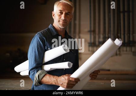 Time to put this plan into action. Portrait of a handsome senior architect holding his plans. Stock Photo