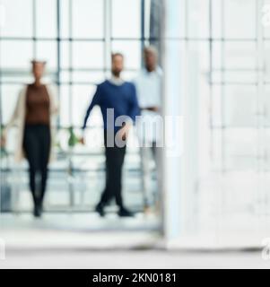 image in blur. group of young business people walking through an office hall.copy of the text space Stock Photo