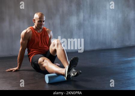 Hes fighting fit. a handsome young man working out in the gym. Stock Photo