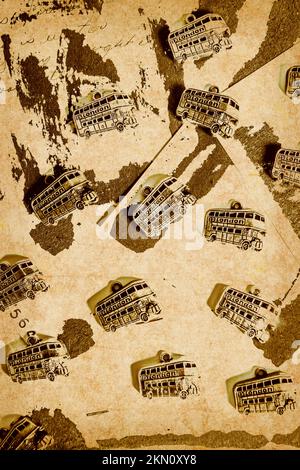 Urban abstract artwork on a patterning of British tourist buses on rustic ripped poster paper. The weathered downtown Stock Photo