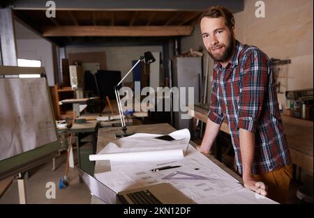 Turning his vision into reality. An architect drawing up plans. Stock Photo