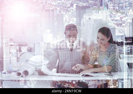 Planning this city from the ground up. Multiple exposure shot of a two colleagues looking at blueprints superimposed on a cityscape. Stock Photo
