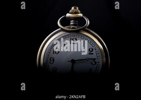 Retro style pocket watch on a dark background Stock Photo