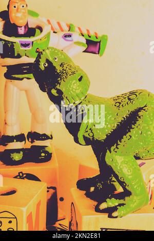 Artistic still life design on a friendly doll dinosaur in stylised poster art. T-Rex toy Stock Photo