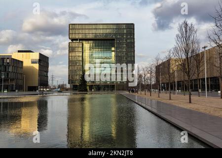 Building ensemble with cube Q1 and water basin in the ThyssenKrupp Quarter, headquarters, corporate headquarters, modern architecture, sunny winter we Stock Photo