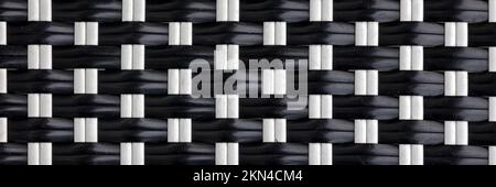 BACKGROUND TEXTURE -  Woven black and white plastic strips in panorama format Stock Photo
