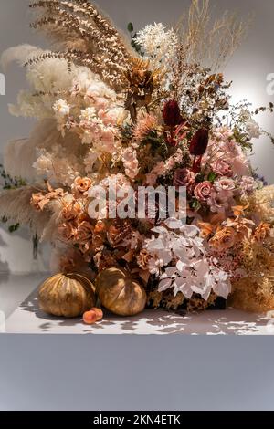 Beautiful showcase of flower shop with large assortment of artificial flowers. Stock Photo