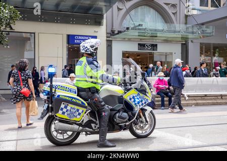 Australian policeman on BMW highway patrol motorbike motorcycle observes street protest in Melbourne city centre,Victoria,Australia Stock Photo