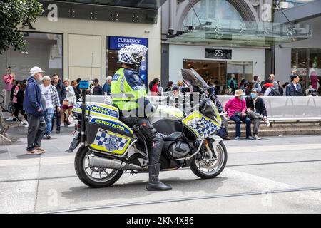 Australian policeman on BMW highway patrol motorbike motorcycle observes street protest in Melbourne city centre,Victoria,Australia Stock Photo
