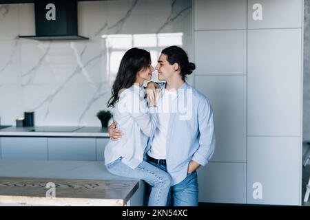 Couple in love hugging and using tablet together. Stock Photo