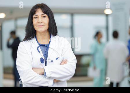 serious doctor in white coat with stethoscope around her neck Stock Photo