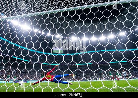 Lusail, Qatar. 26th Nov, 2022. Soccer: World Cup, Argentina - Mexico, Preliminary round, Group C, Matchday 2, Lusail Iconic Stadium, Argentina's Lionel Messi (m) makes the goal 1:0 against Mexico's goalkeeper Guillermo Ochoa (l). Credit: Tom Weller/dpa/Alamy Live News Stock Photo