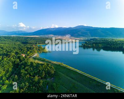Professional breeding of freshwater fish in intermountain blue lake with round nets. Cloudy weather, Rhodope mountains, Europe Stock Photo