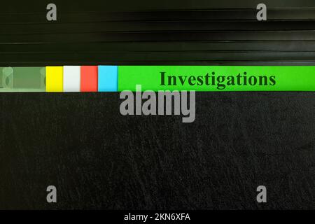 Investigations file record in black binder folder. Crime, legal and incident investigation concept. Stock Photo