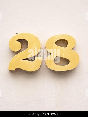 A vertical closeup of plaque plate number address of '28' house Stock Photo