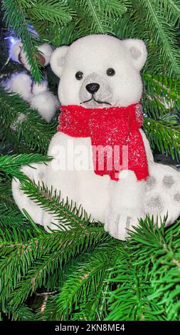 Christmas and New Year. Festive background with fir branches, Christmas tree, New Year's toys produced by the factory. Photo zone. Stock Photo