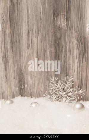 Christmas Wooden gray background with Christmas tree decorations and artificial snow Stock Photo