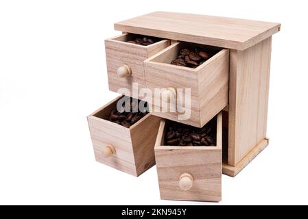 Wooden box with cells filled with coffee beans. Coffee beans scattered side by side Isolated on white background Top view Stock Photo