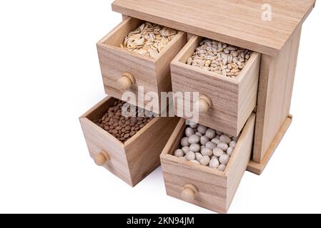 Pattern of raw cereals, beans and seeds, top view texture, mix of groats in square wooden box. Small wooden box with cells with beans lentils oatmeal Stock Photo
