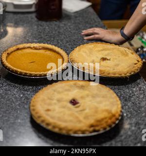 a top down view of three pies just before they are sliced up for serving at a family gathering Stock Photo