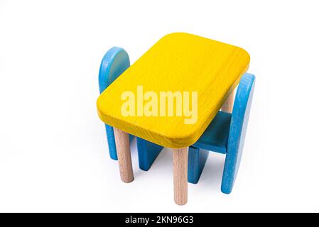 a wooden blue toy chair, a sofa, two chairs with a table, a yellow table, blue upholstered wooden chairs. yellow lamp on isolated white background fro Stock Photo