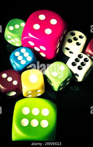 Colourful casino dice in large and small form. Numbers of a betting chance Stock Photo