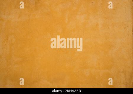 Vintage house plastered beige painted wall closeup as colored background Stock Photo