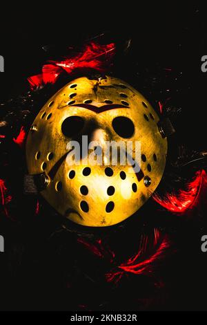 Macabre madness in a still life scene with a horror hockey mask laying abandoned in the fields of a killers wake Stock Photo