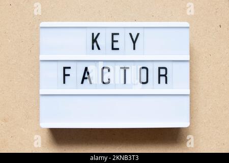 Lightbox with word key factor on wood background Stock Photo
