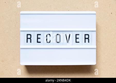 Lightbox with word recover on wood background Stock Photo