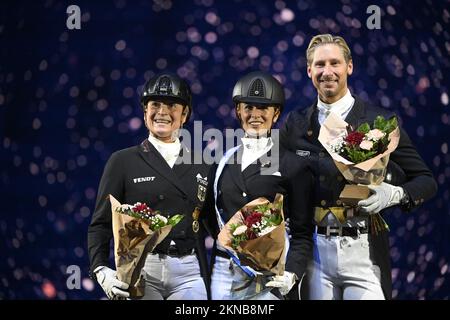 L-R Isabell Werth, Germany, placed second, Jessica Von Bredow-Werndl , Germany, won and  Patrik Kittel, Swede, placed third in the FEI Grand Prix kür Stock Photo