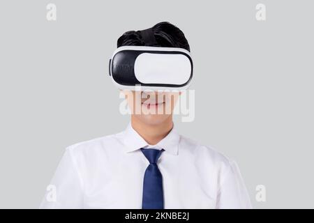 Experience of young asian businessman wearing VR Headset with excited isolated on white background, metaverse or virtual reality tech, innovation of f Stock Photo