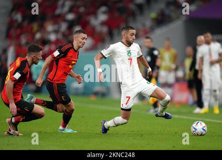Morocco's Hakim Ziyech (right) and Belgium’s Timothy Castagne battle for the ball during the FIFA World Cup Group F match at the Al Thumama Stadium, Doha, Qatar. Picture date: Sunday November 27, 2022. Stock Photo