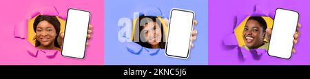 Three excited young multicultural women holding three big cell phones Stock Photo
