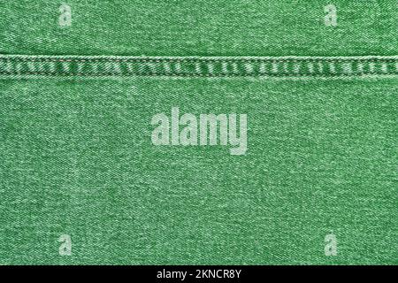 Denim jeans texture background. Texture of green colored cotton fabric with decorative seam. Stiched texture jean background. Fiber and fabric structu Stock Photo