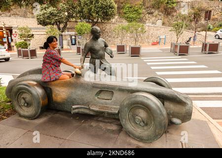 Photo opportunity,at,statue,sculpture,monument,of,Juan Manuel Fangio,Fangio,famous,Argentina,Argentinian,icon,iconic,Grand Prix,F1,Formula 1,racing,driver,near,harbour,Monte Carlo,Monaco,South of France,France,French,Europe,European,August,summer.Mediterranean,coast,city,state,country,rich,millionaires, Stock Photo
