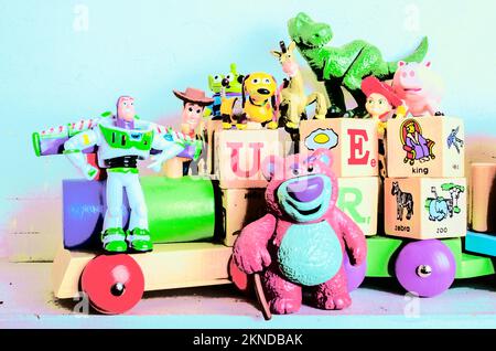 Pop art poster on a creative scene of comic toys in imaginative playtime. Carriage of cartoon characters Stock Photo