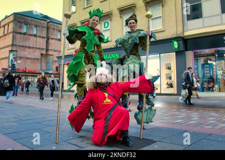 Glasgow, Scotland, UK 27th November, 2022. Style Mile Christmas Carnival saw shoppers on the shopping streets surrounding the style mile being entertained to a Christmas theme with fancy costumes and carol singers bedecked in Christmas attire.Featuring at this year’s festive celebration are the Beauty and The Beast dance troupe, Giant Elfies, Rudolf and Friends troupe, Holly and the Ivy troupe, Giant Elfies and the Snowman pipe band.  Gerard Ferry/Alamy Live News Stock Photo