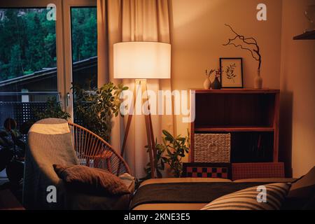 Lamp illuminating a decorative living room with warm light Stock Photo