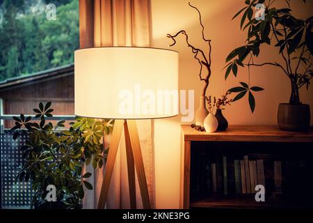 Lamp illuminating a living room with warm light Stock Photo